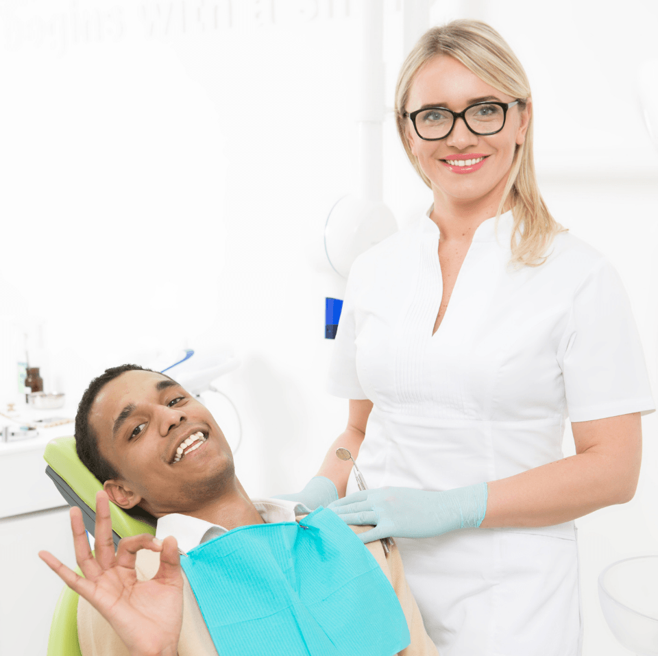 lady dentist and her patient man smiling