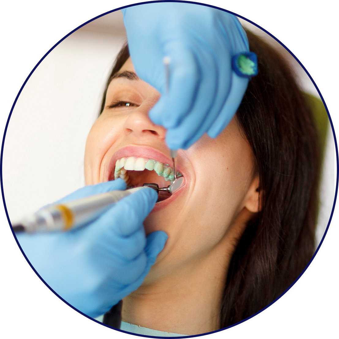 Woman having her teeth professionally cleaned by a dentist