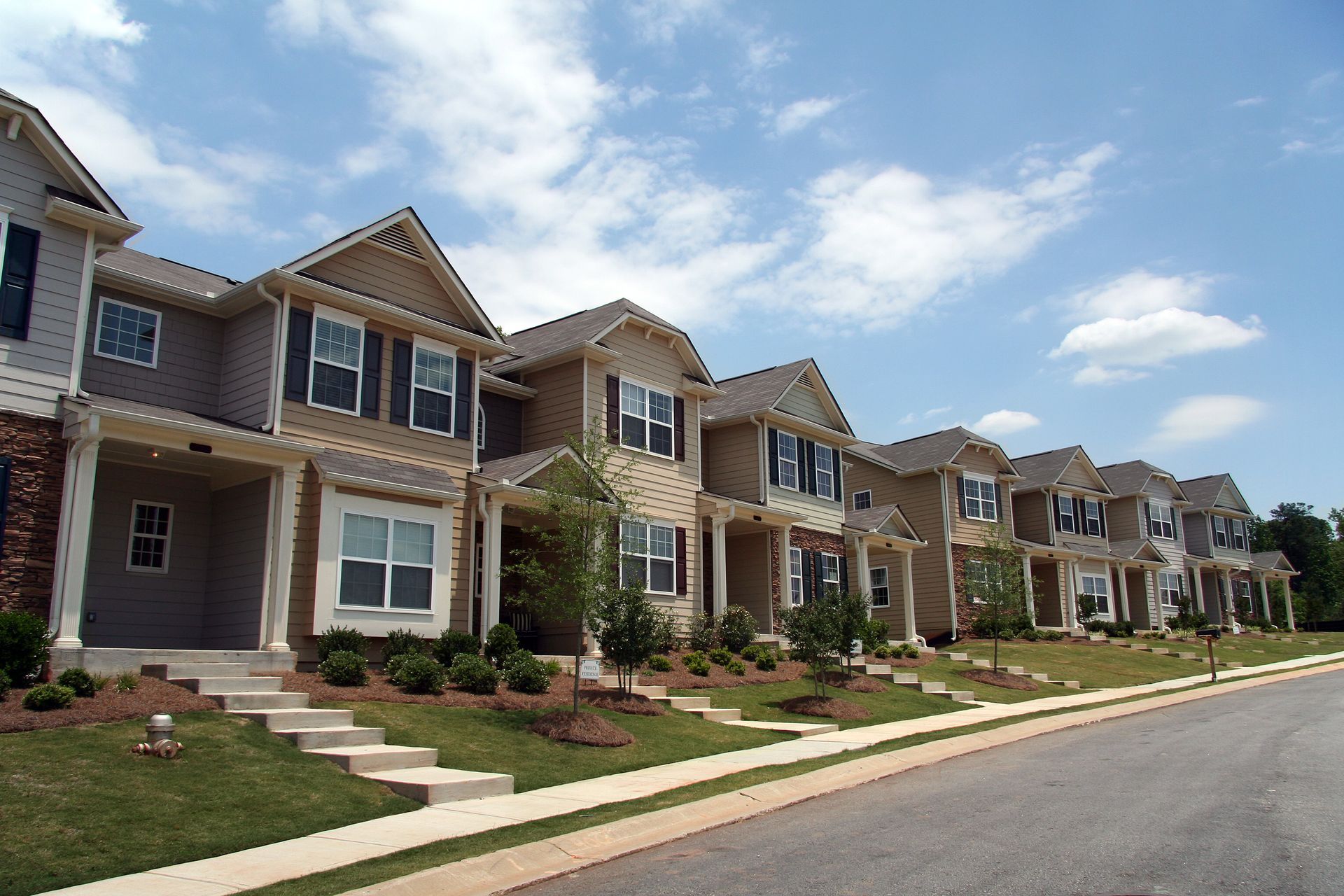Row of modern townhomes along a residential street.