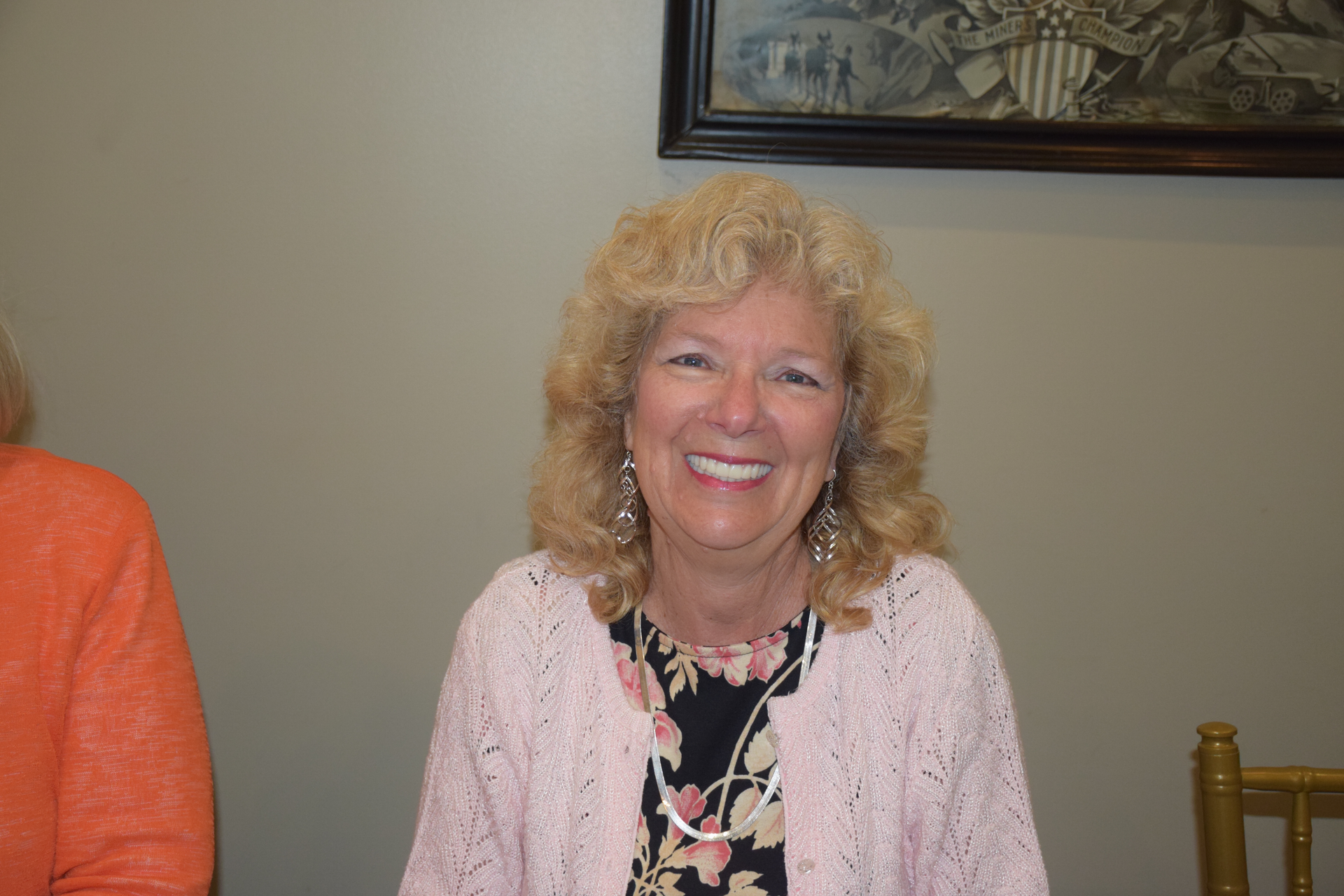 A close up of a woman wearing glasses and smiling