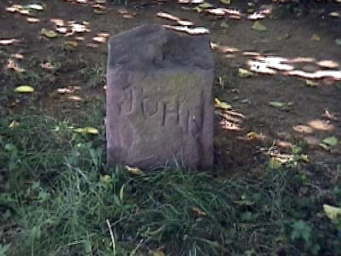 A gravestone with the name john carved into it