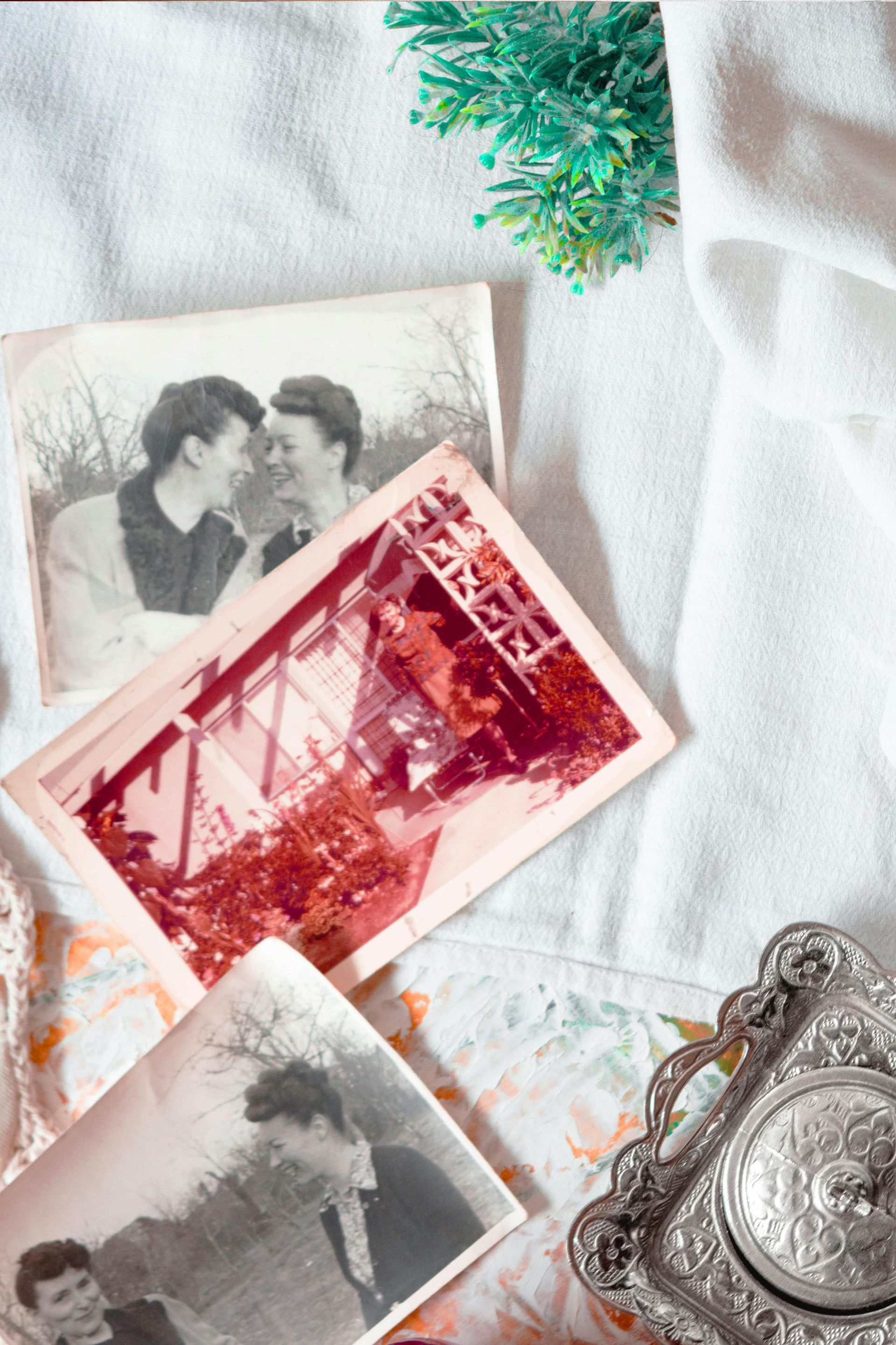 A bunch of old photos are sitting on a table.