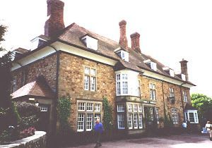 A large stone house with a lot of windows and chimneys