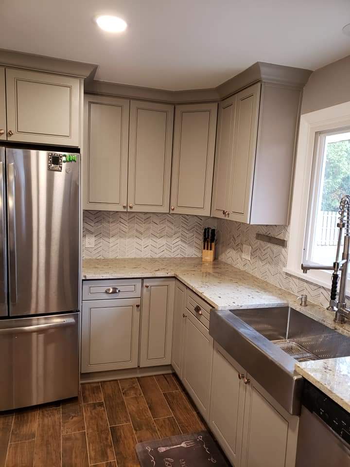 Kitchen with gray cabinets, stainless steel appliances, and a farmhouse sink.