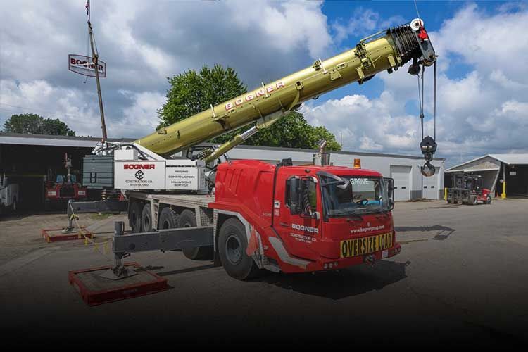 A Red and Yellow Crane is Parked in a Parking lot | Wooster, OH | Bogner Construction Company