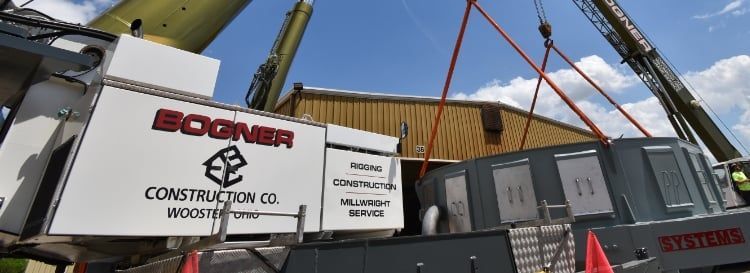 A Crane is Lifting a Container in Front of a Building | Wooster, OH | Bogner Construction Company