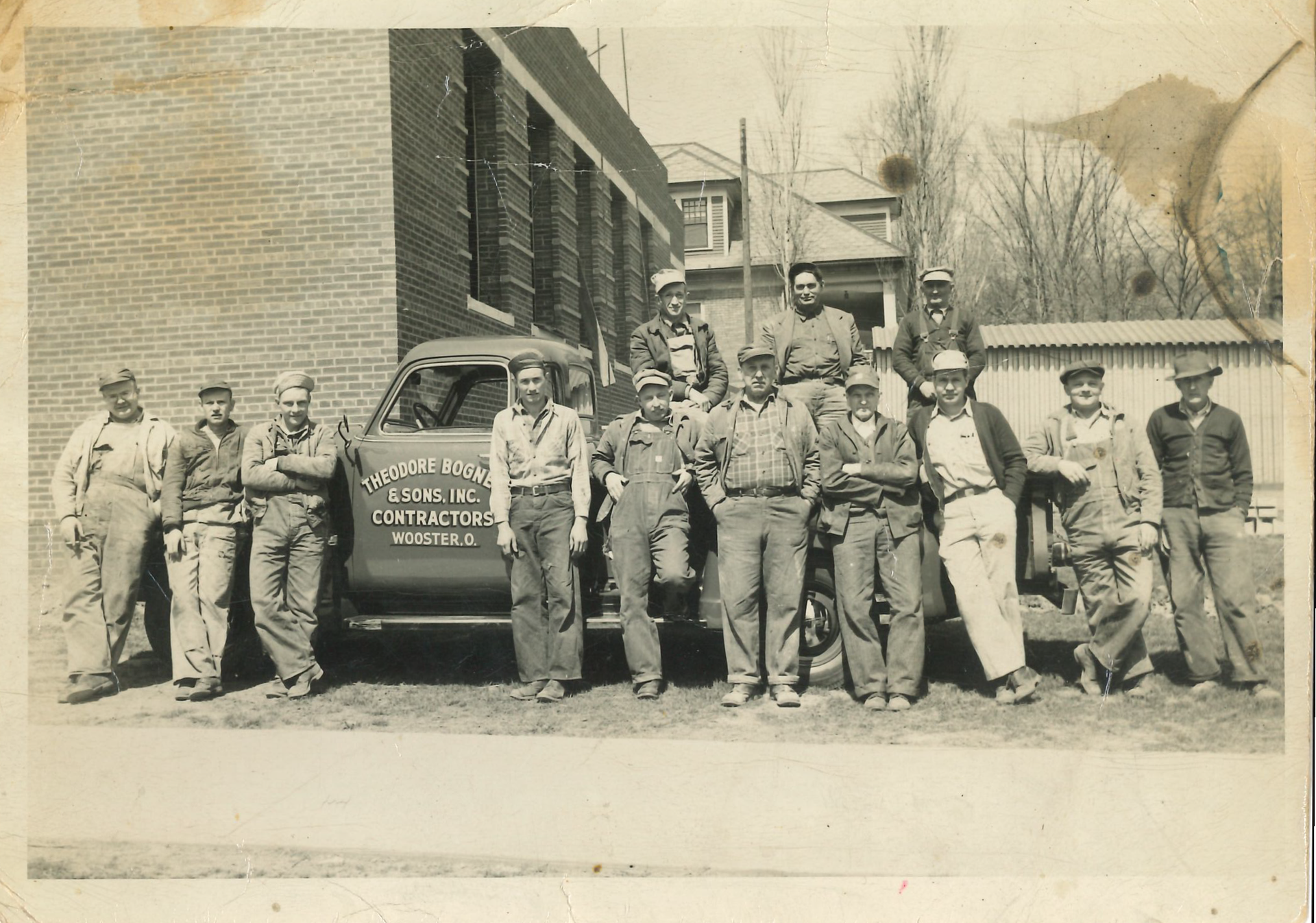 A Black and White Photo of a Group of Men Standing in Front of a Truck | Wooster, OH | Bogner Construction Company