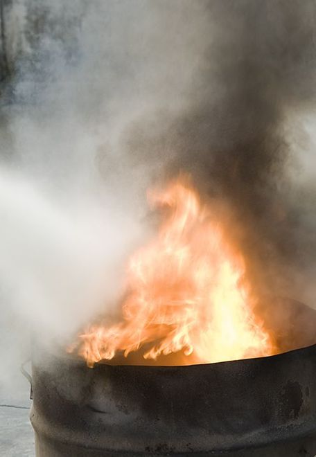 Smoke is coming out of a fire in a barrel