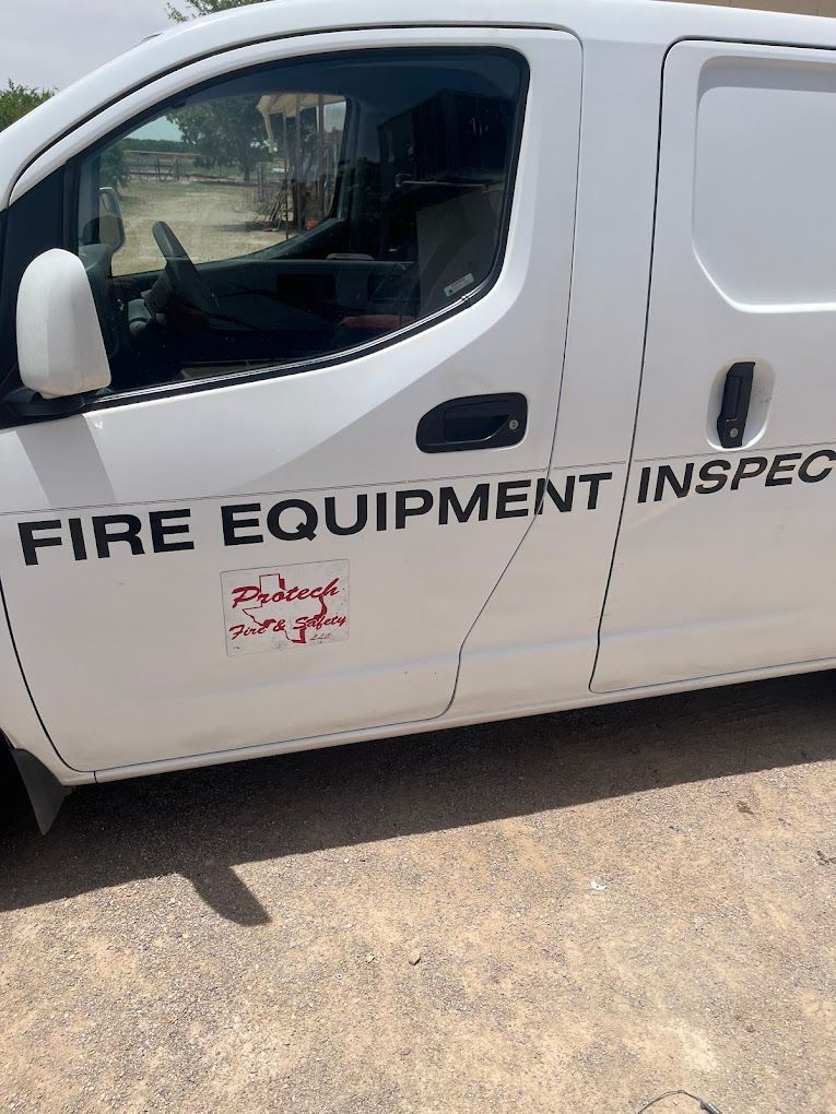 A white van with the words fire equipment inspect written on it