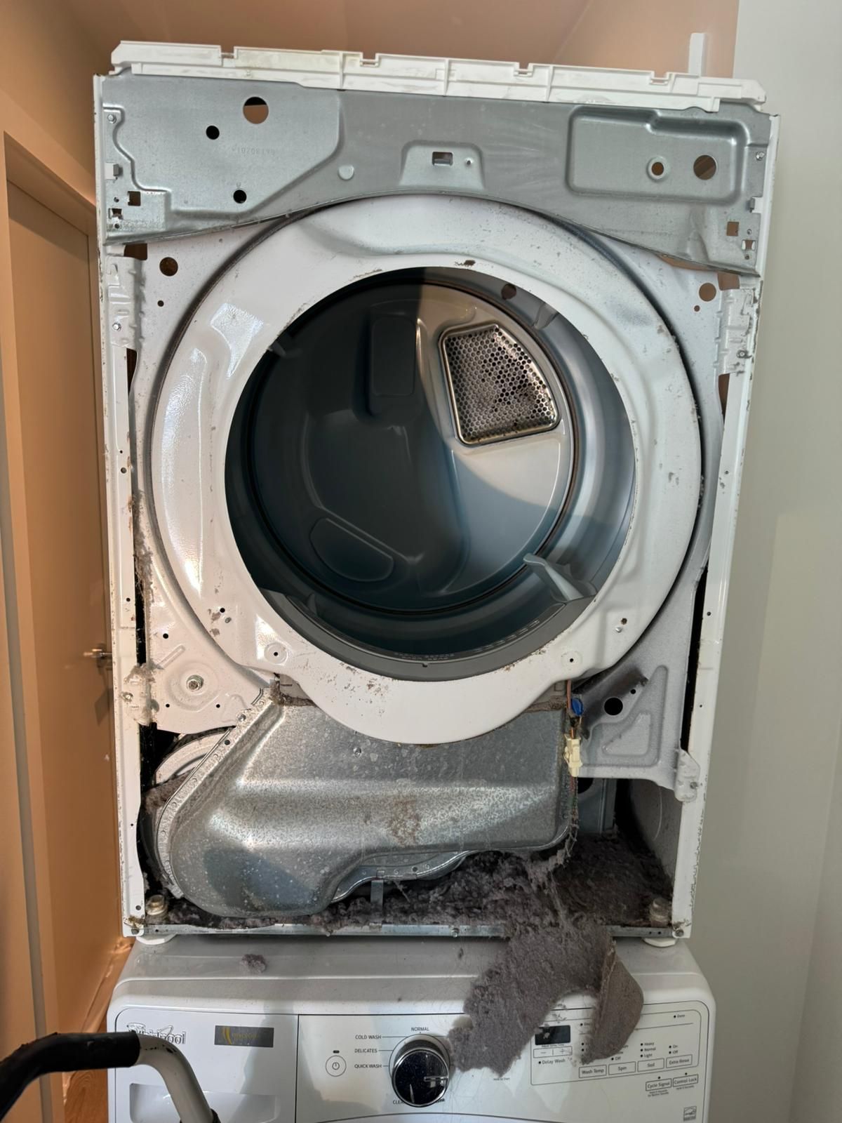 A clothes drying machine with the face panel removed.