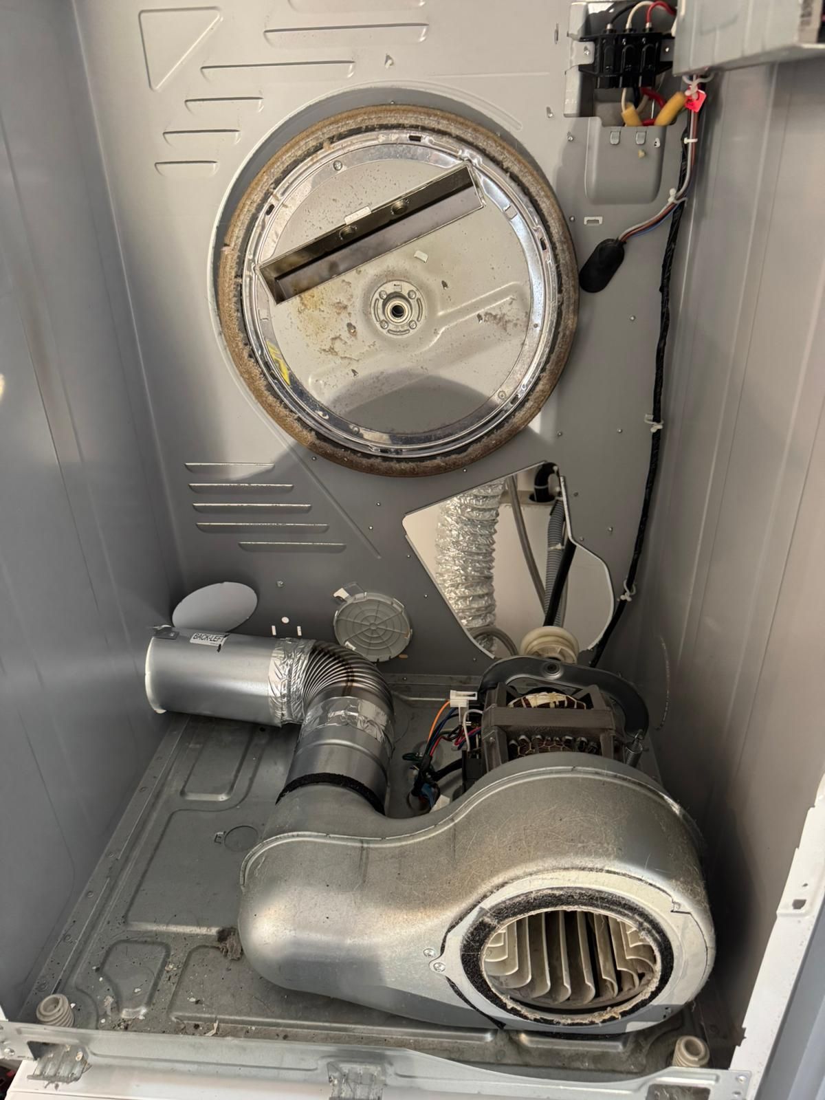 The inside of a dryer with the drum removed