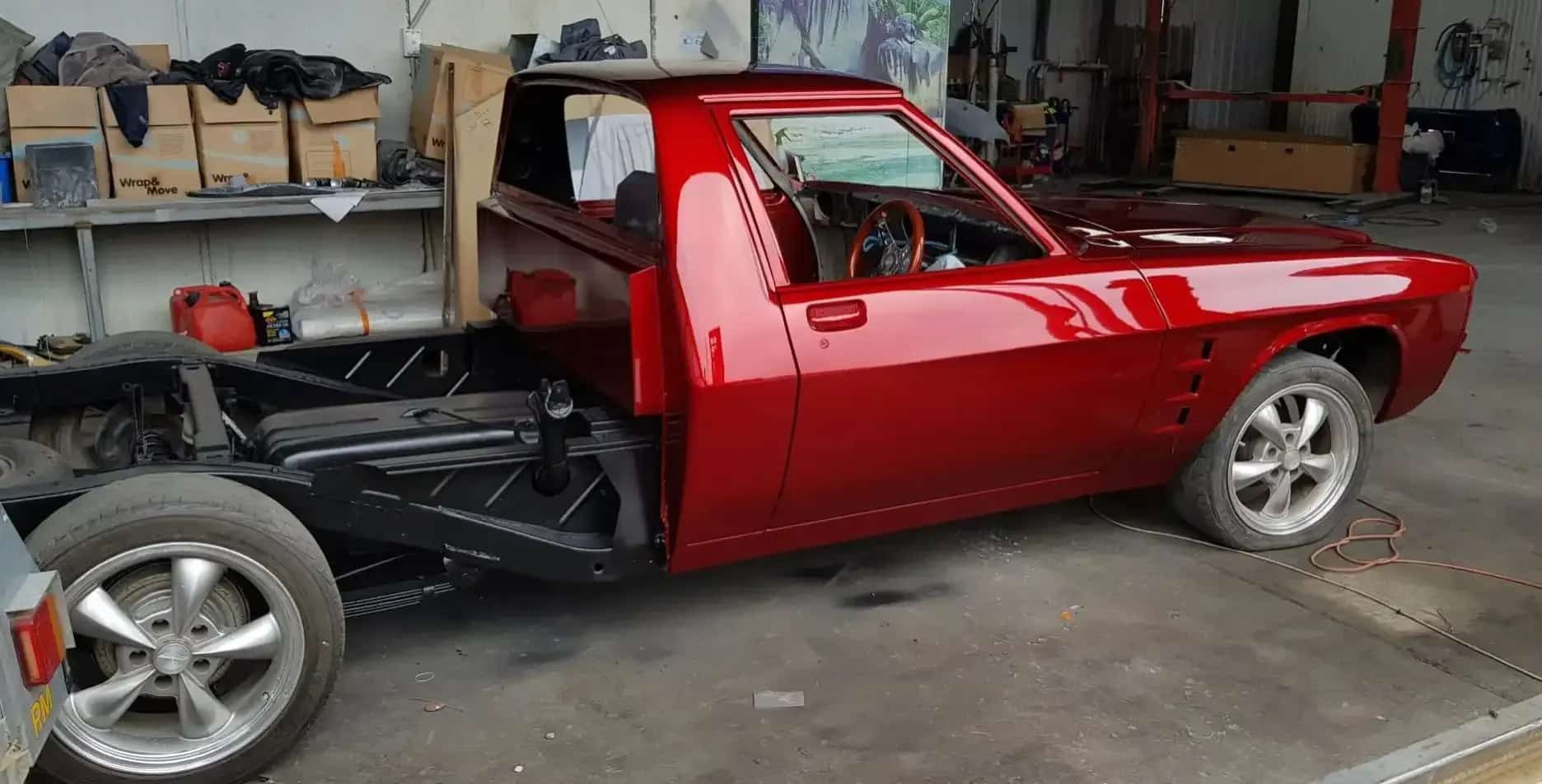 A Red Pickup Truck Is Parked in A Garage — Dentmaster Refinishing In Bungalow, QLD