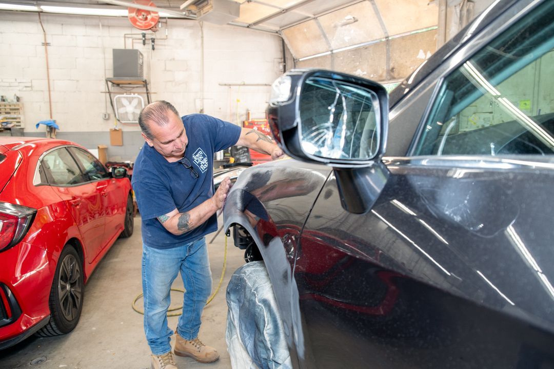 Working on a vehicle at Town Line Auto Body