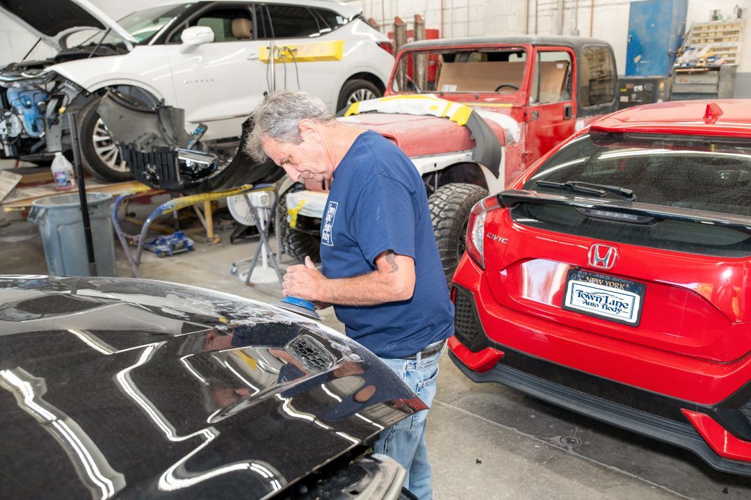 Working on a vehicle at Town Line Auto Body