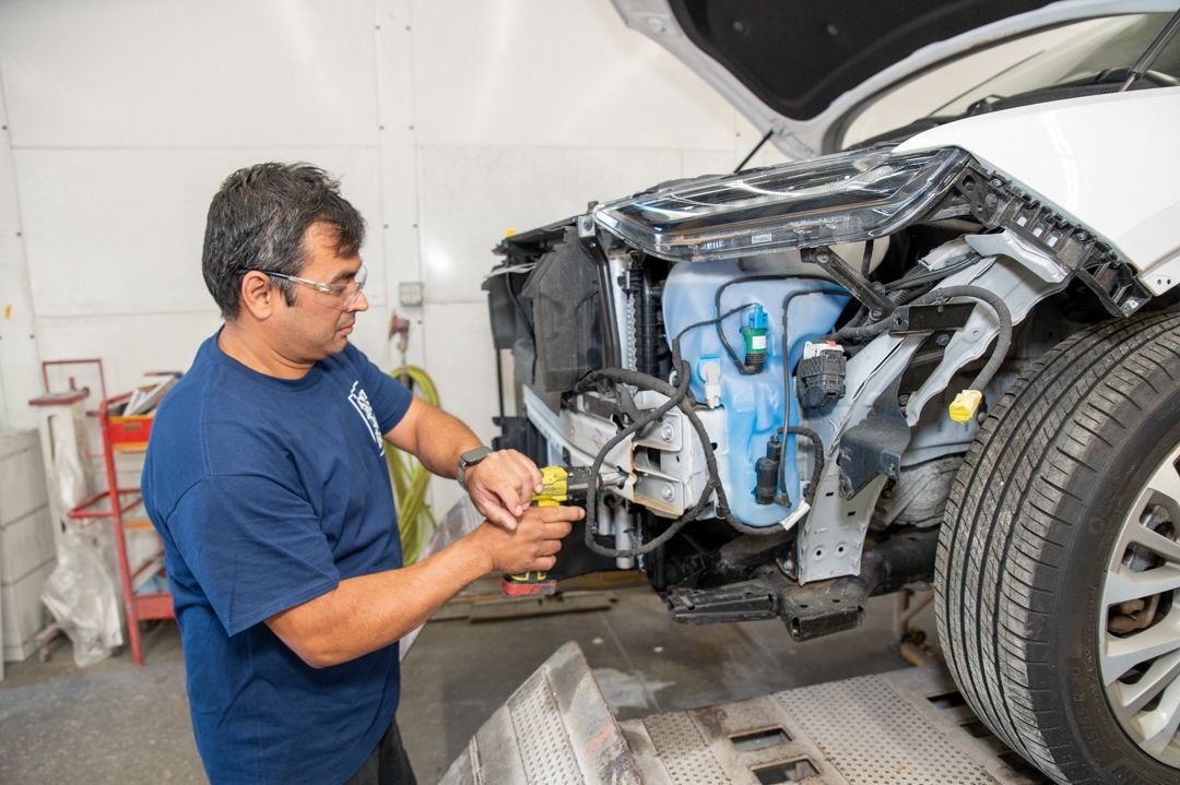 Working on a vehicle at Town Line Auto Body