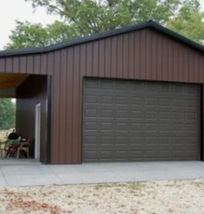 Brown garage with an attached carport; set outdoors.