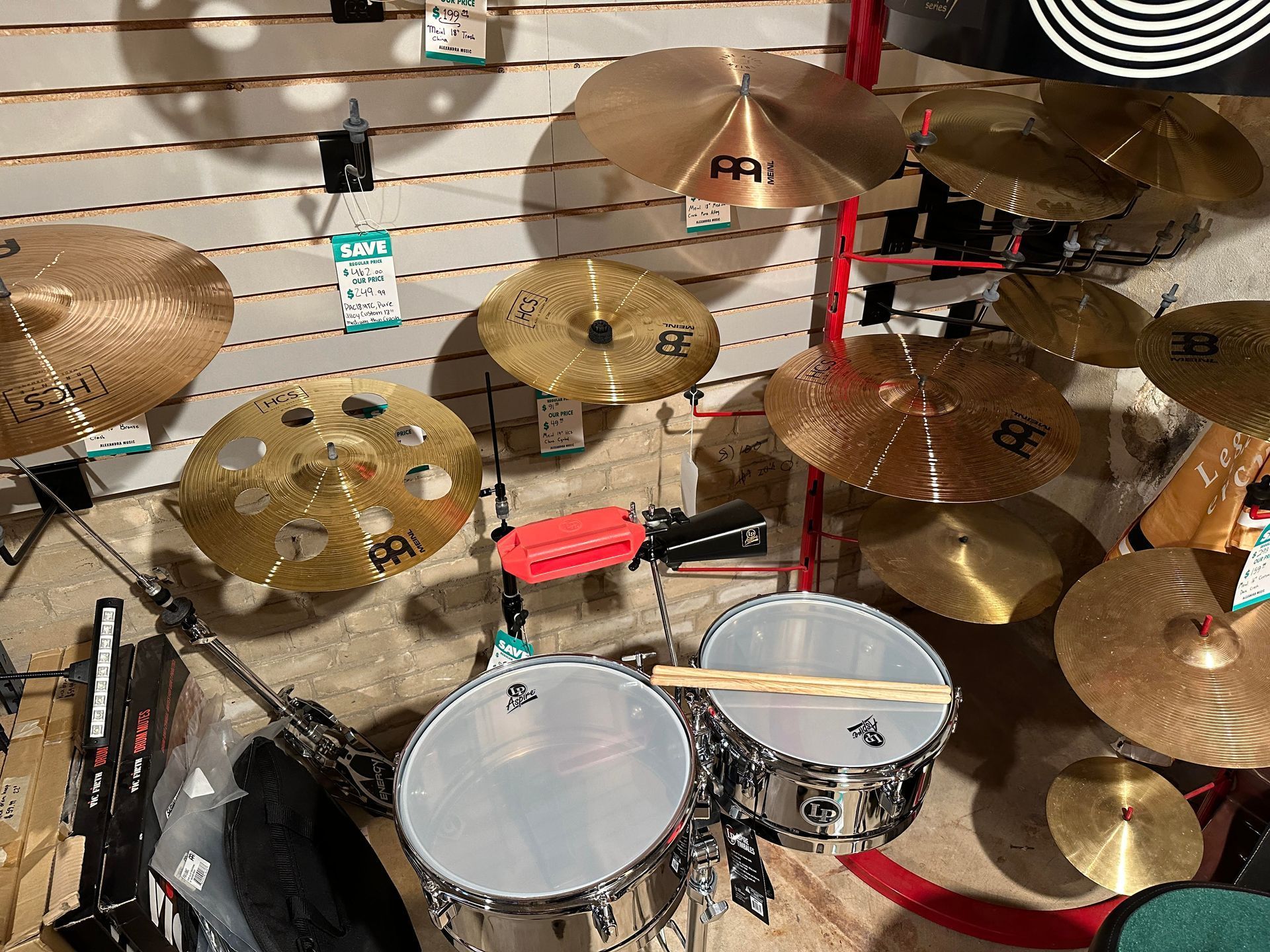 Drum set with cymbals of various sizes on display. A drumstick lies across the snare drum.