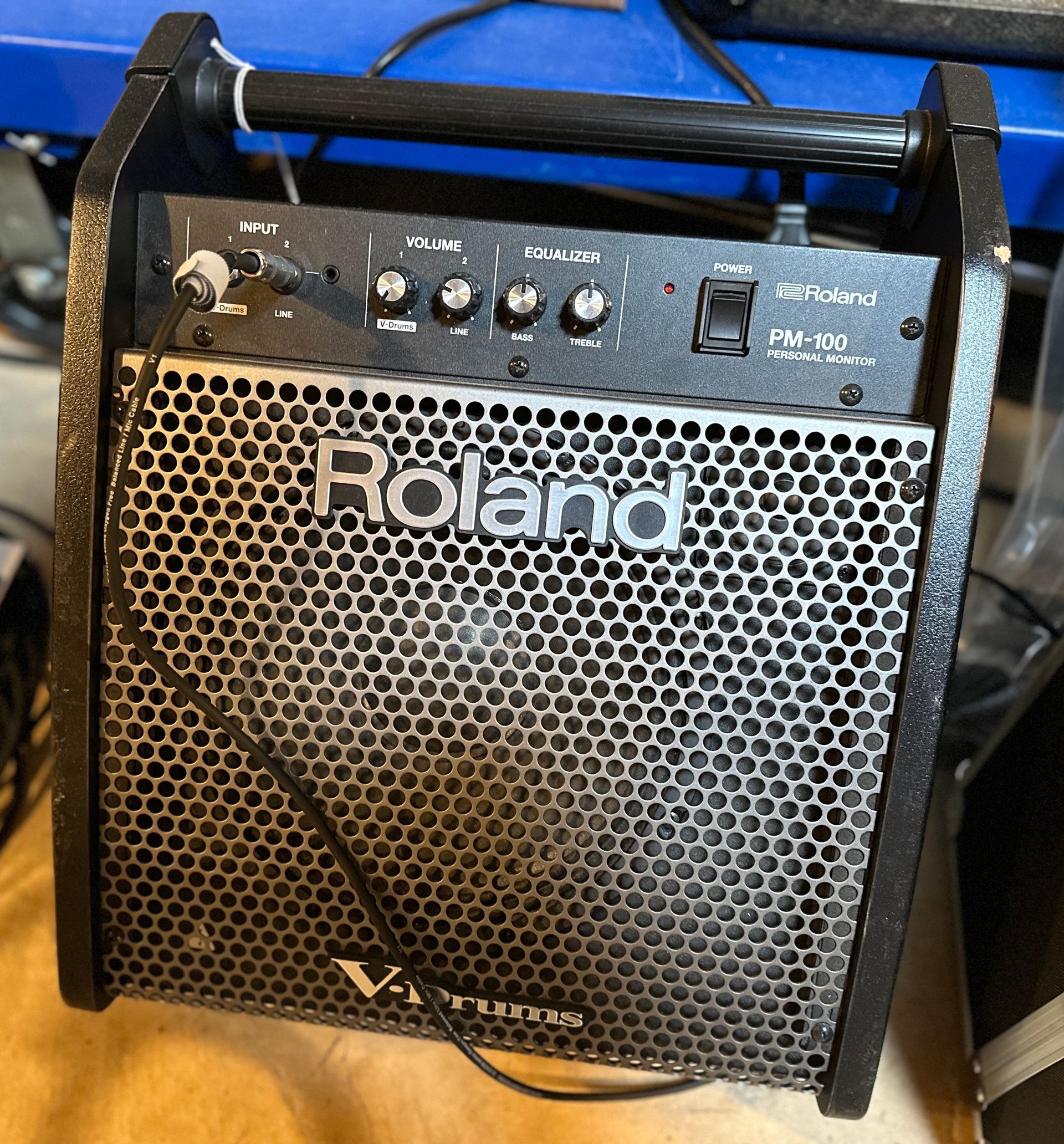 Roland Micro Cube guitar amplifier with black metal grill and controls.