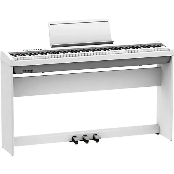 White digital piano with music stand and three pedals.