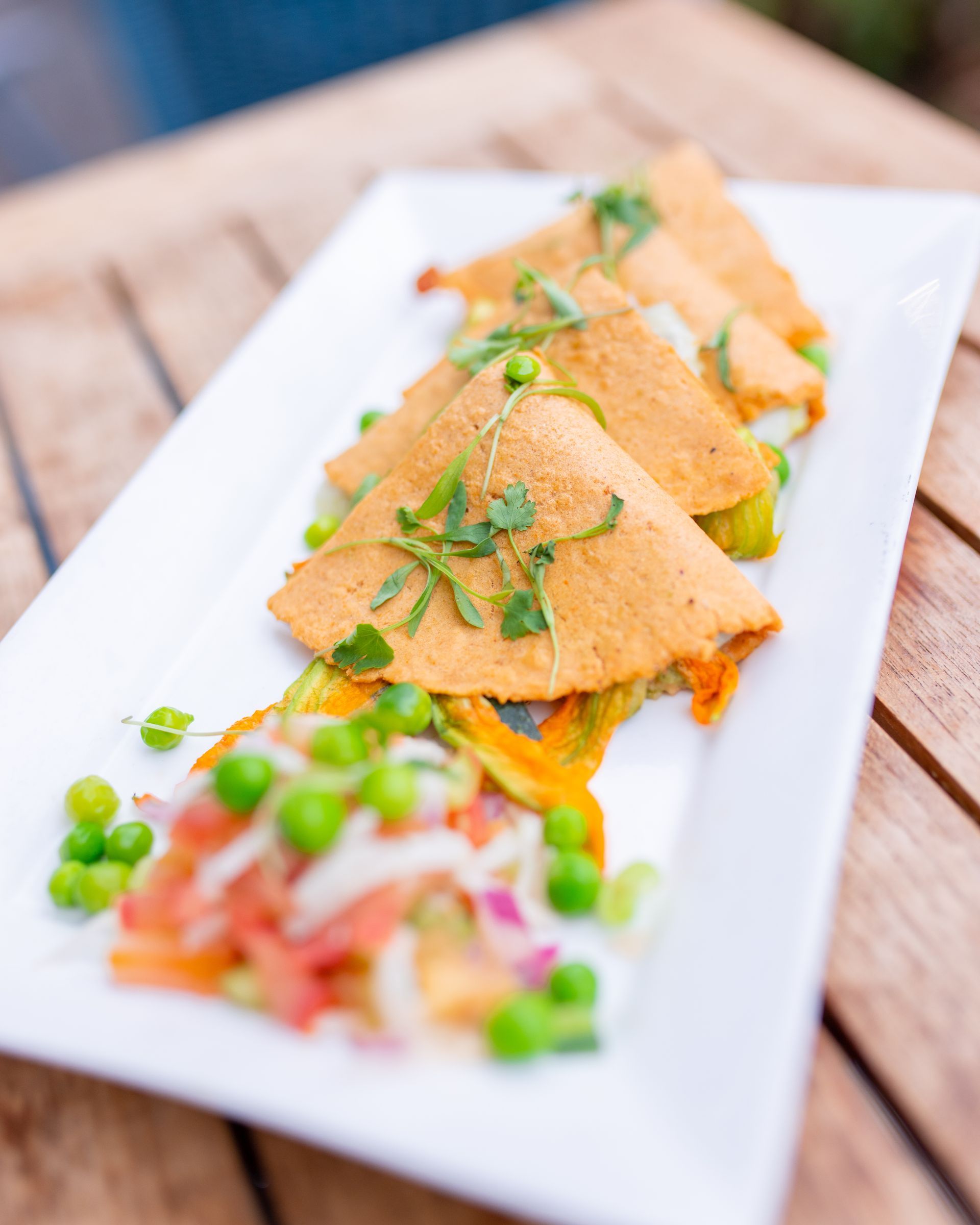 A close up of a plate of food on a wooden table