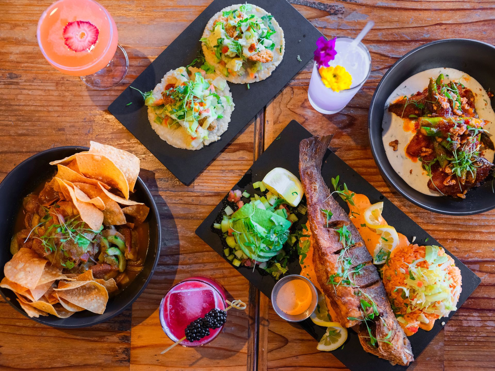 A table topped with plates of food and drinks.