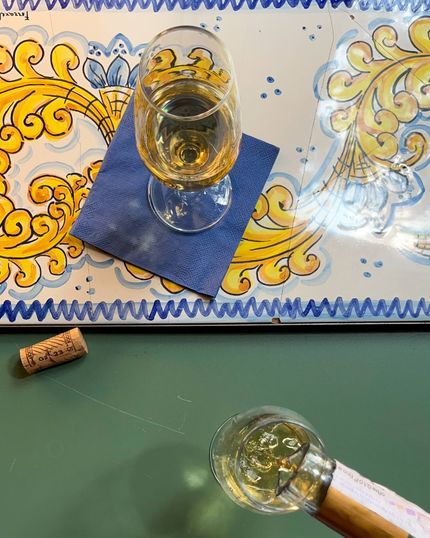 Una bottiglia di vino e un bicchiere di vino su un tavolo