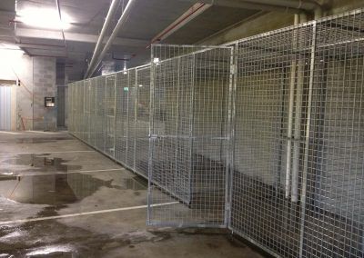 Galvanised steel weld mesh storage cages in a row