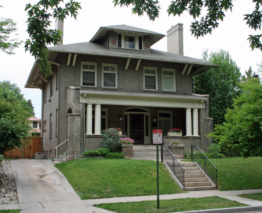 A large house with a no parking sign in front of it