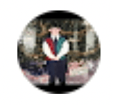 A man in a vest and tie is standing in a circle.