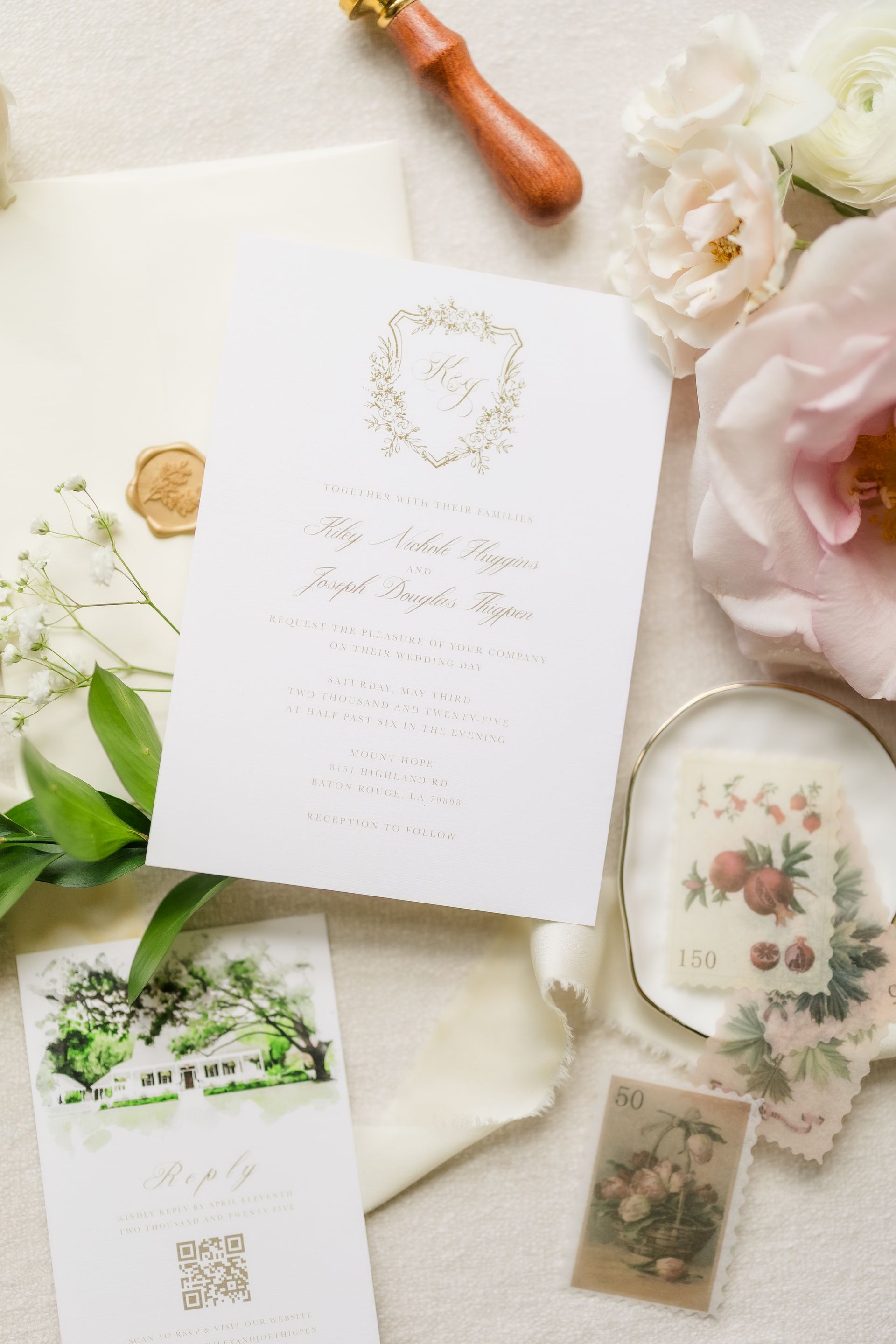 Wedding invitation suite with florals, calligraphy, and wax seal.