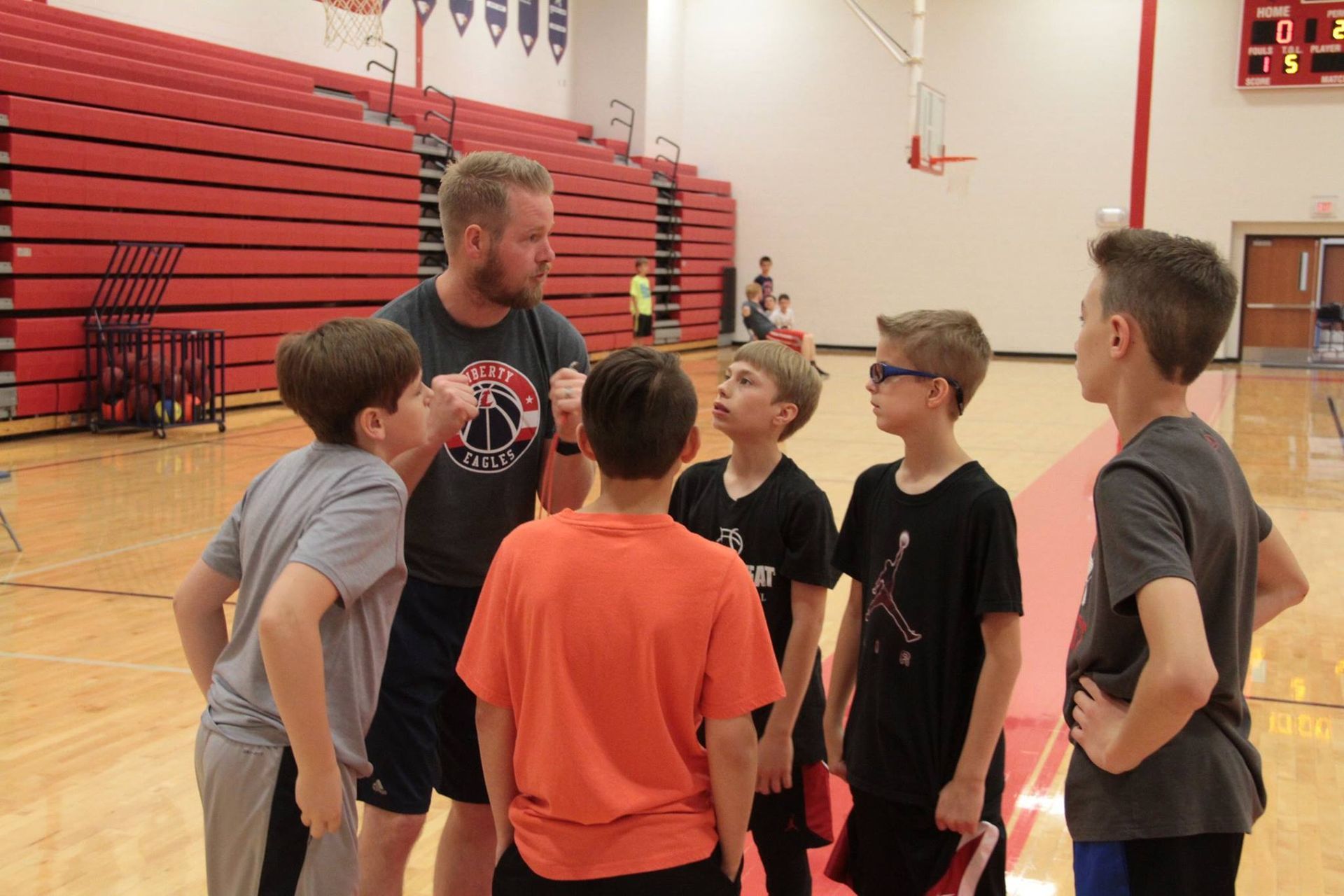 liberty eagles basketball boys huddle with coach