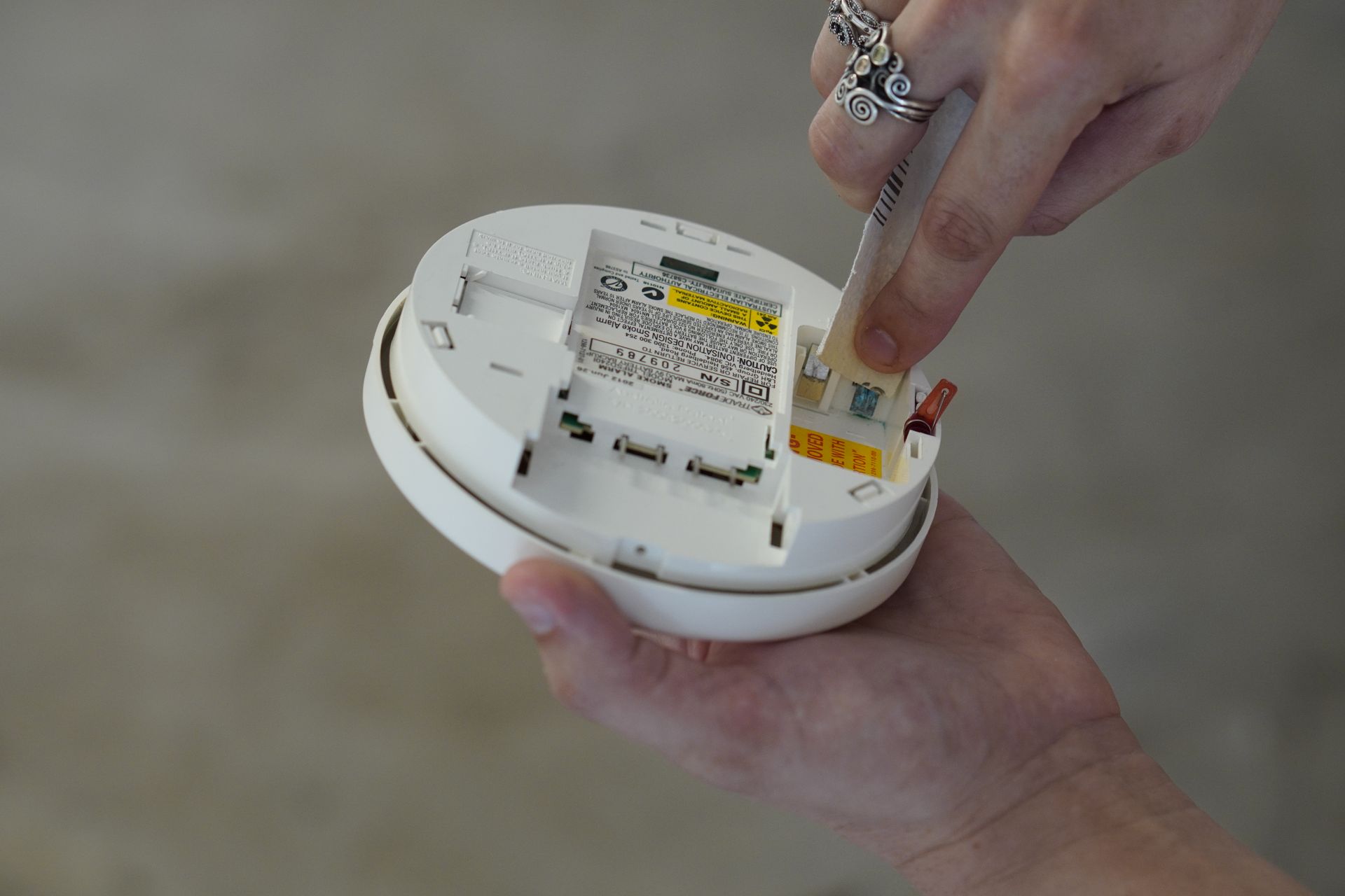 Electrician Installing New Smoke Alarm Unit