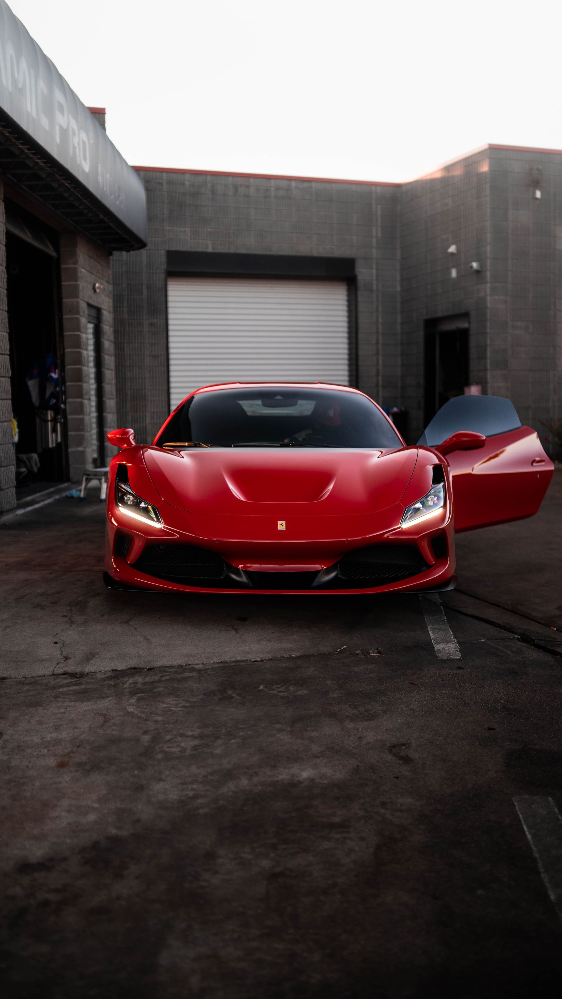 a person wearing black gloves is cleaning a car with a towel .