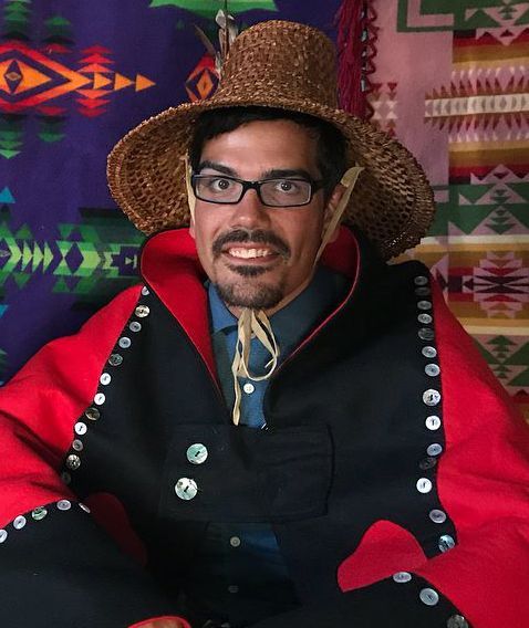 a native american man in tribal wardrobe