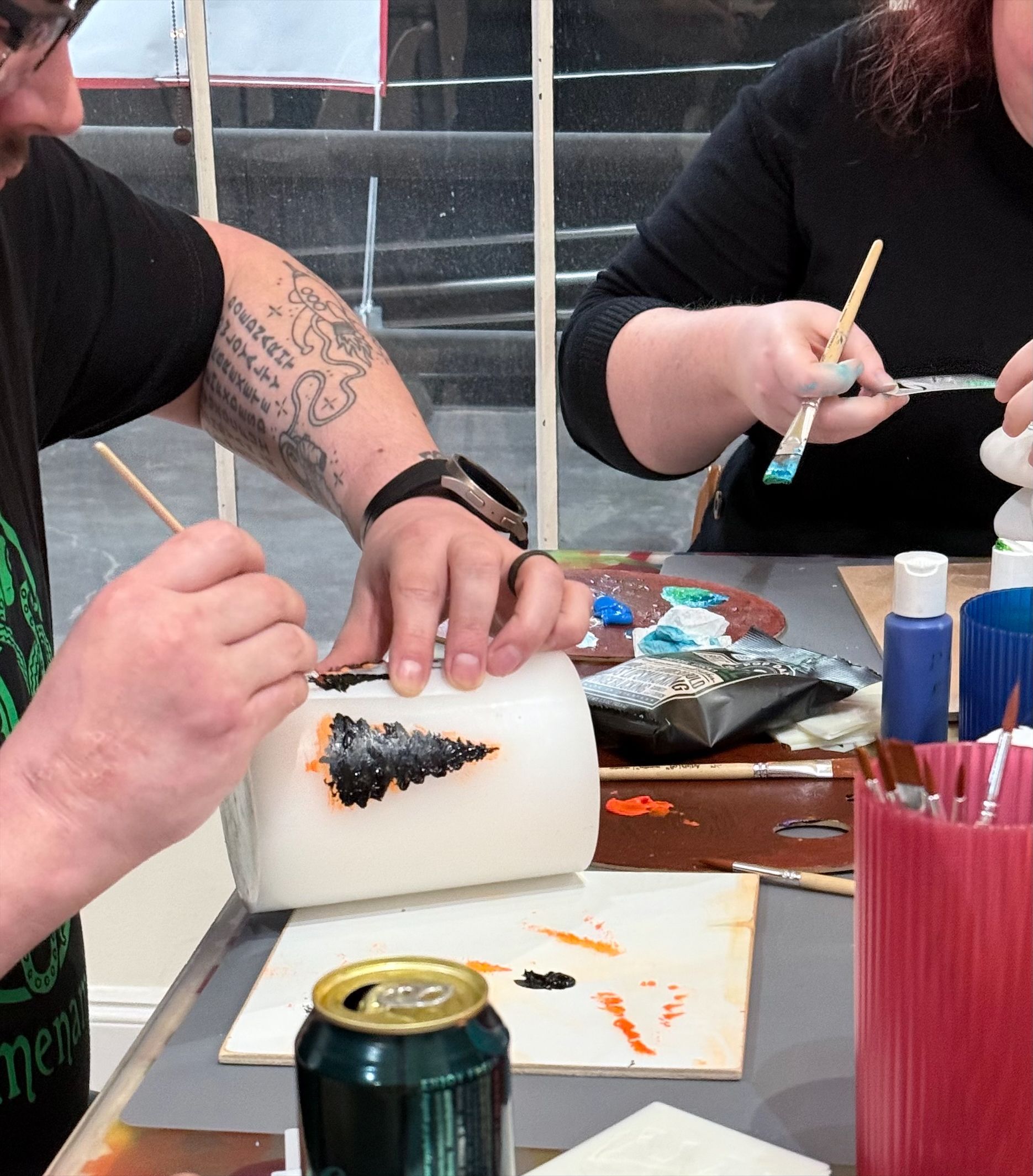 man painting a candle