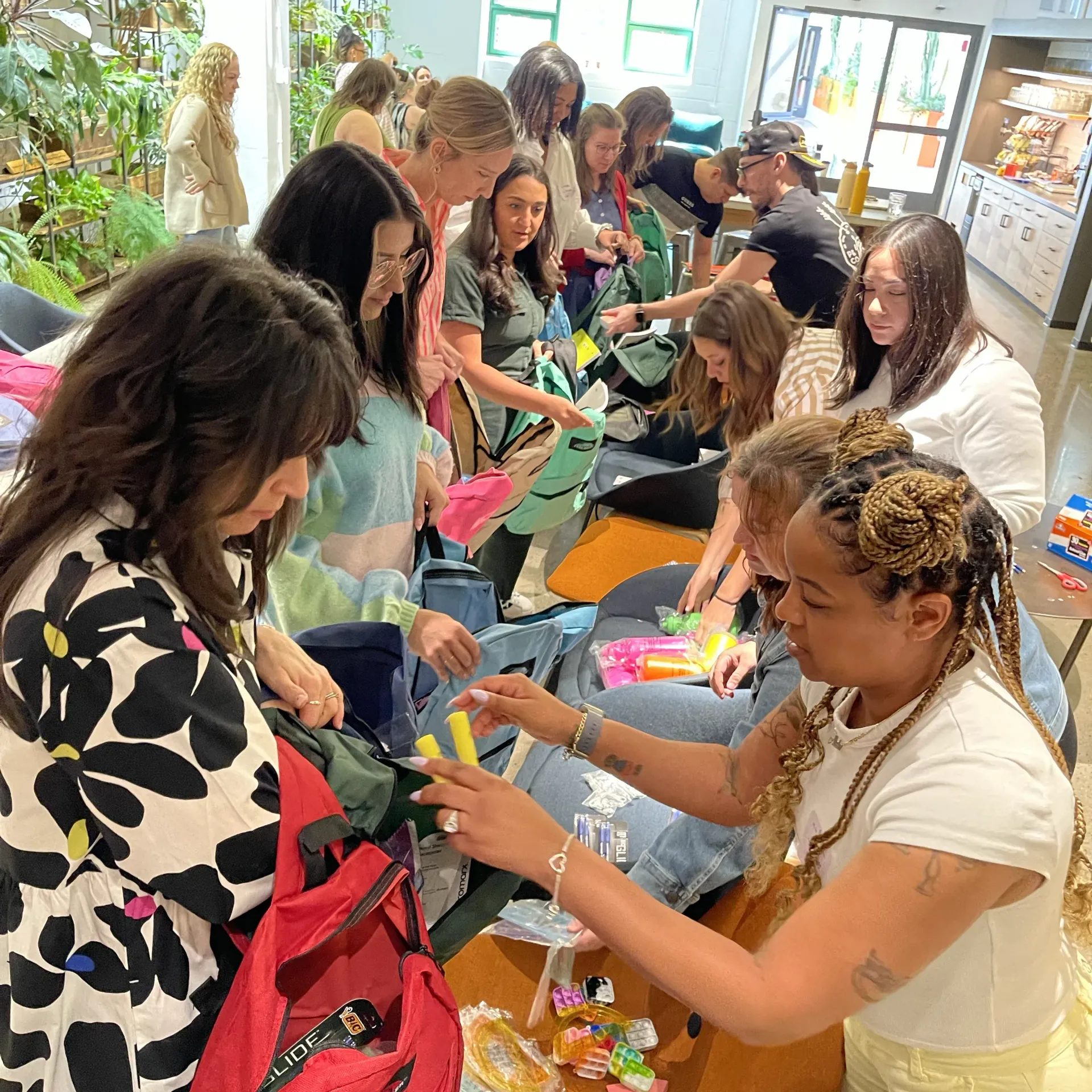 a group of people painting on a large canvass