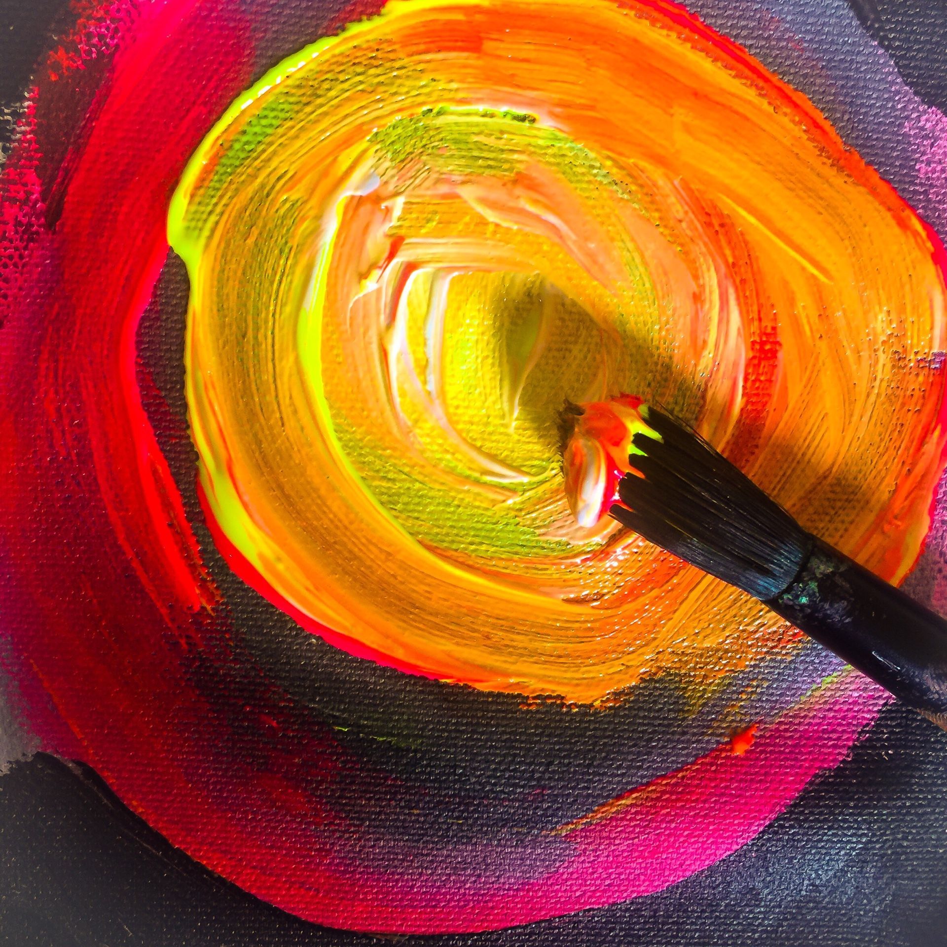a paint brush painting a yellow circle