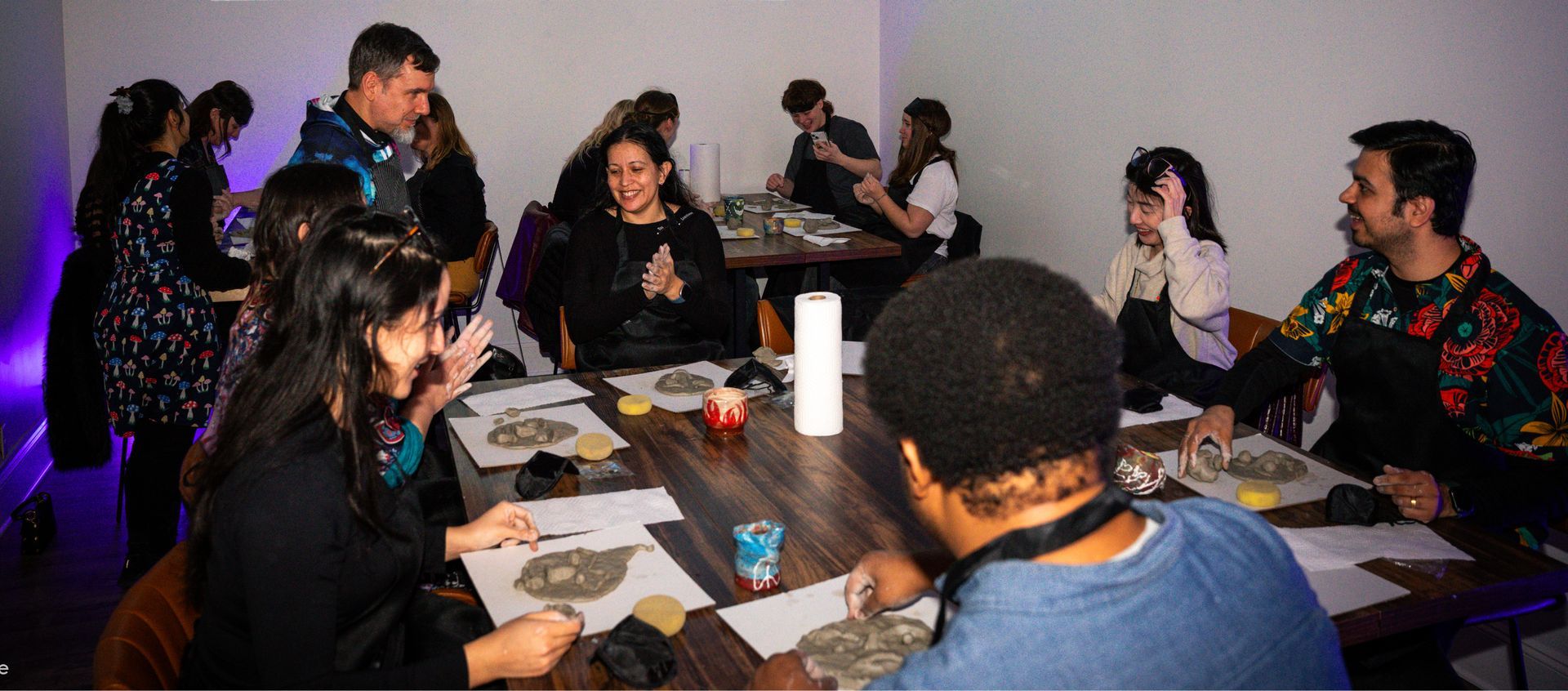 a group of people interacting with clay