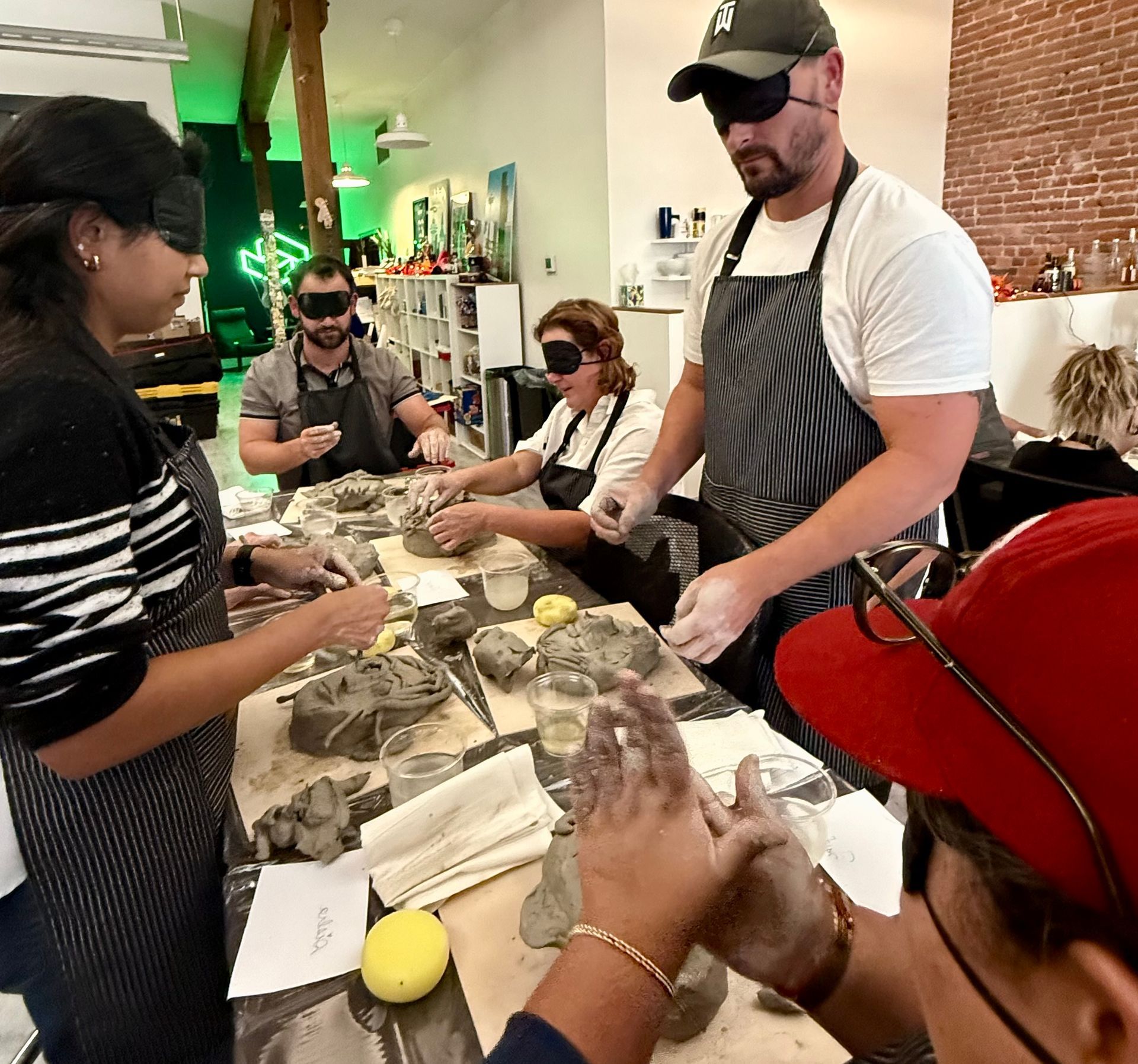 5 people sculpting with blindfolds on