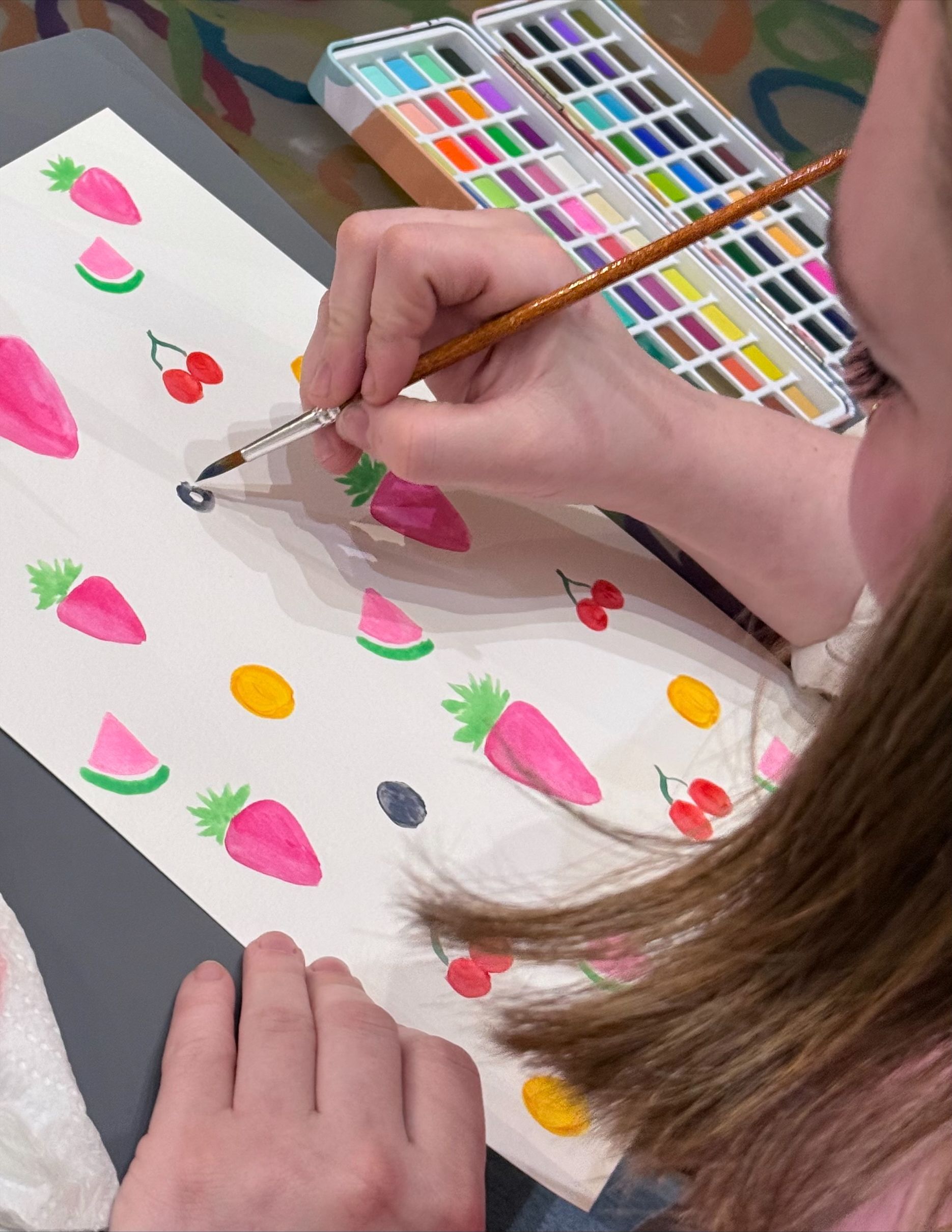 woman painting with water colours