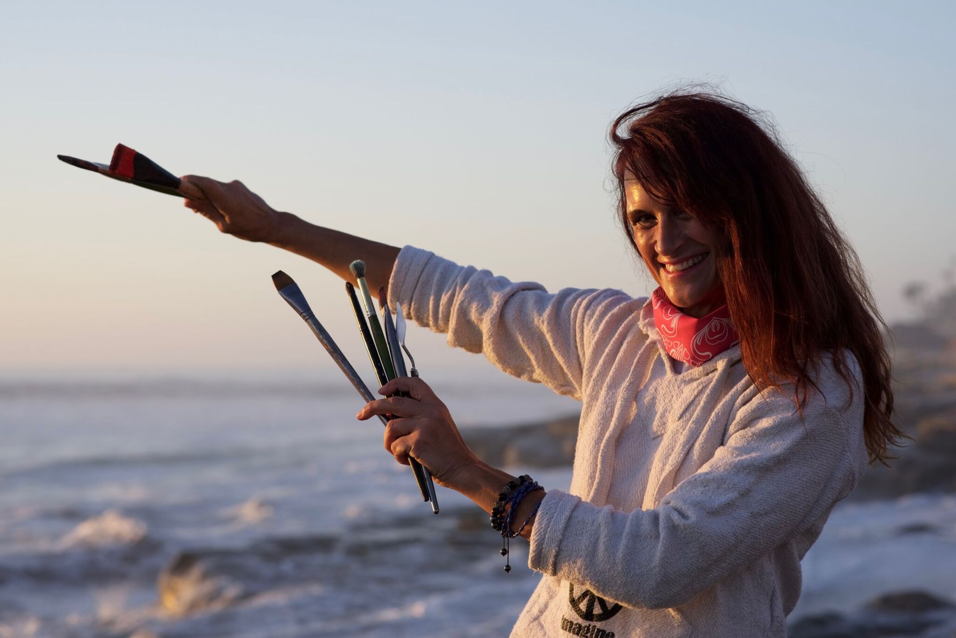woman holding paint brushes