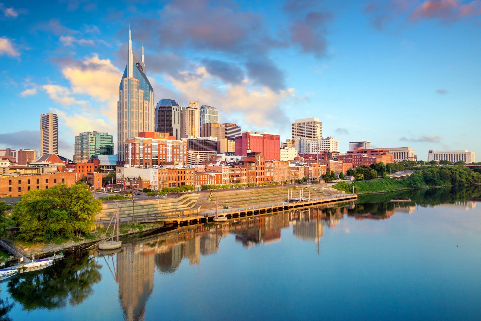 A city skyline is reflected in a body of water.