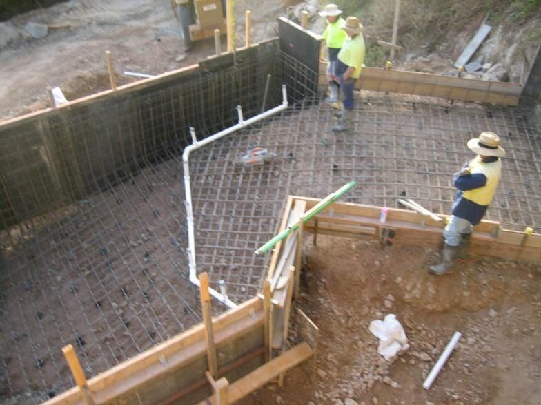 A Couple of Men Are Working on a Construction Site — Rockscene Pools in Bentley Park, QLD