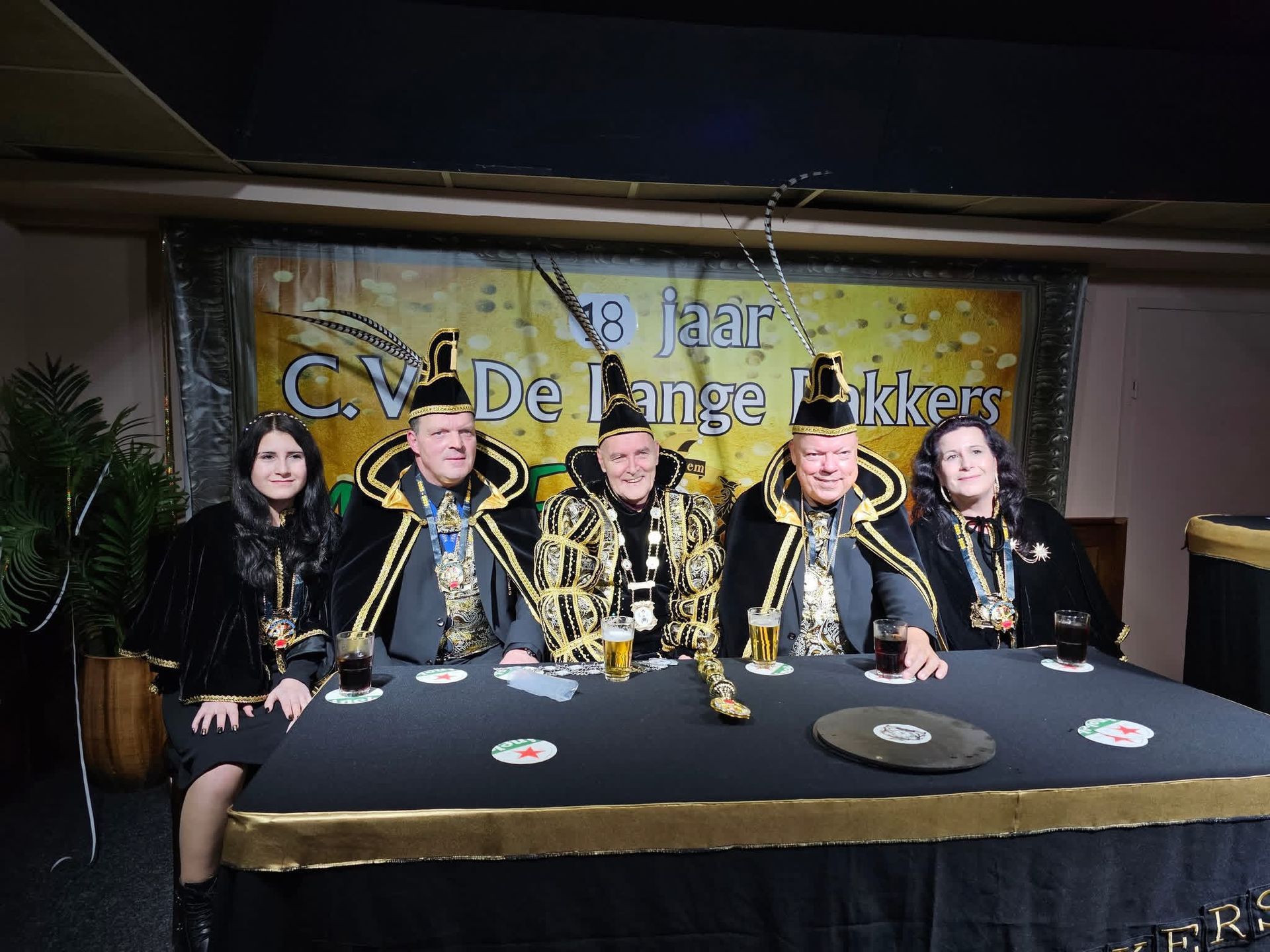 Grilling food with tongs. Bowling pins lined up, reflecting on the floor.