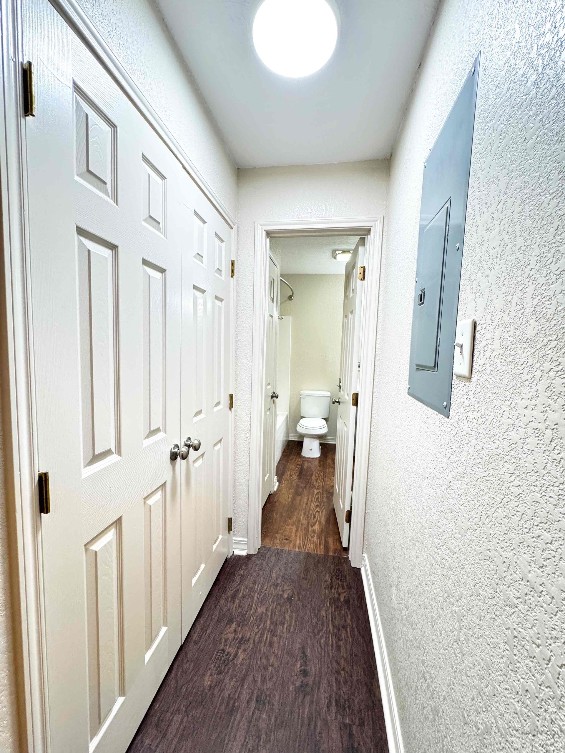 A bedroom with a mattress and a ceiling fan.