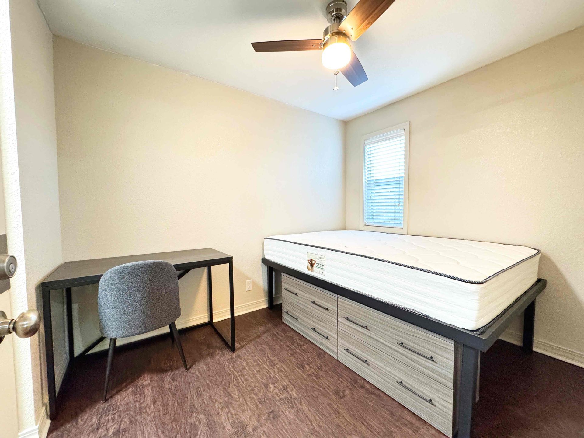 A long hallway leading to a bathroom with a toilet.