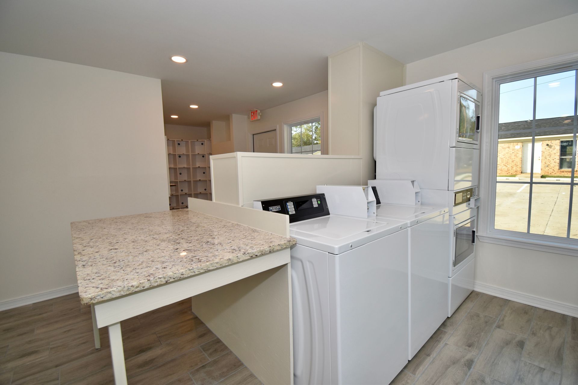 A laundry room with a washer and dryer and a counter.
