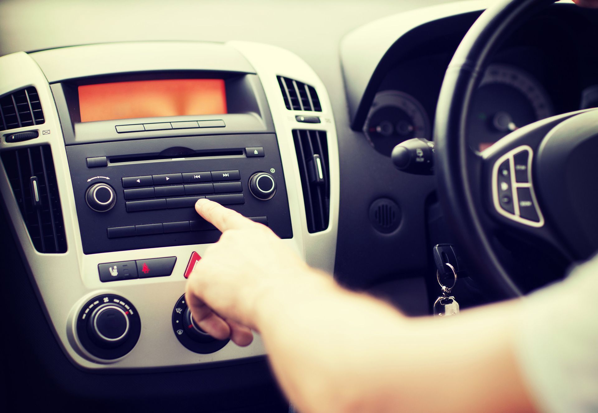 a person is adjusting the radio in a car