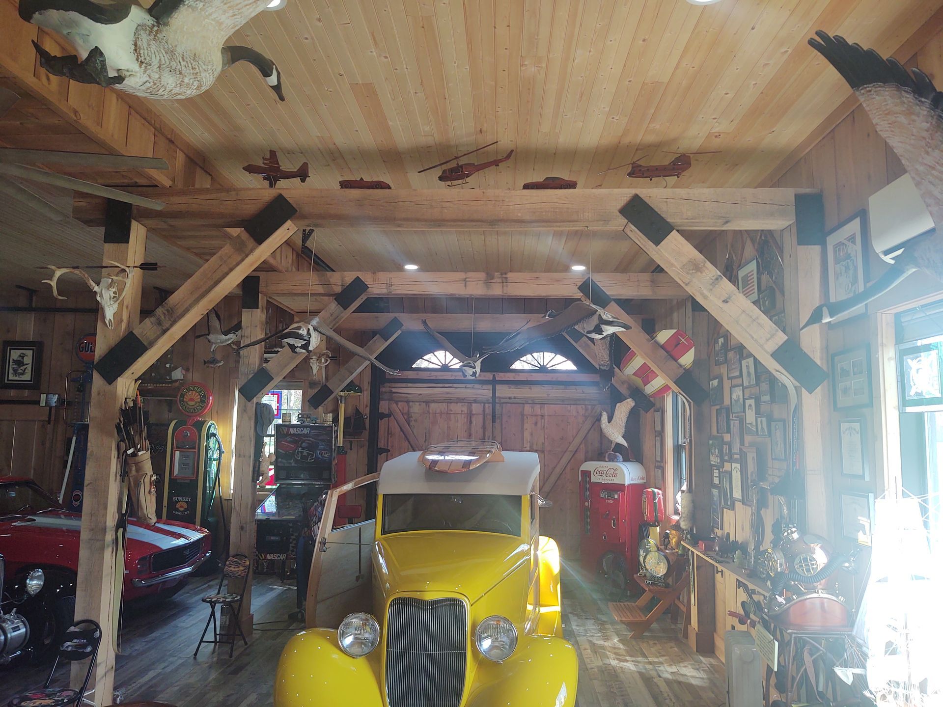 A yellow car is parked in a wooden garage