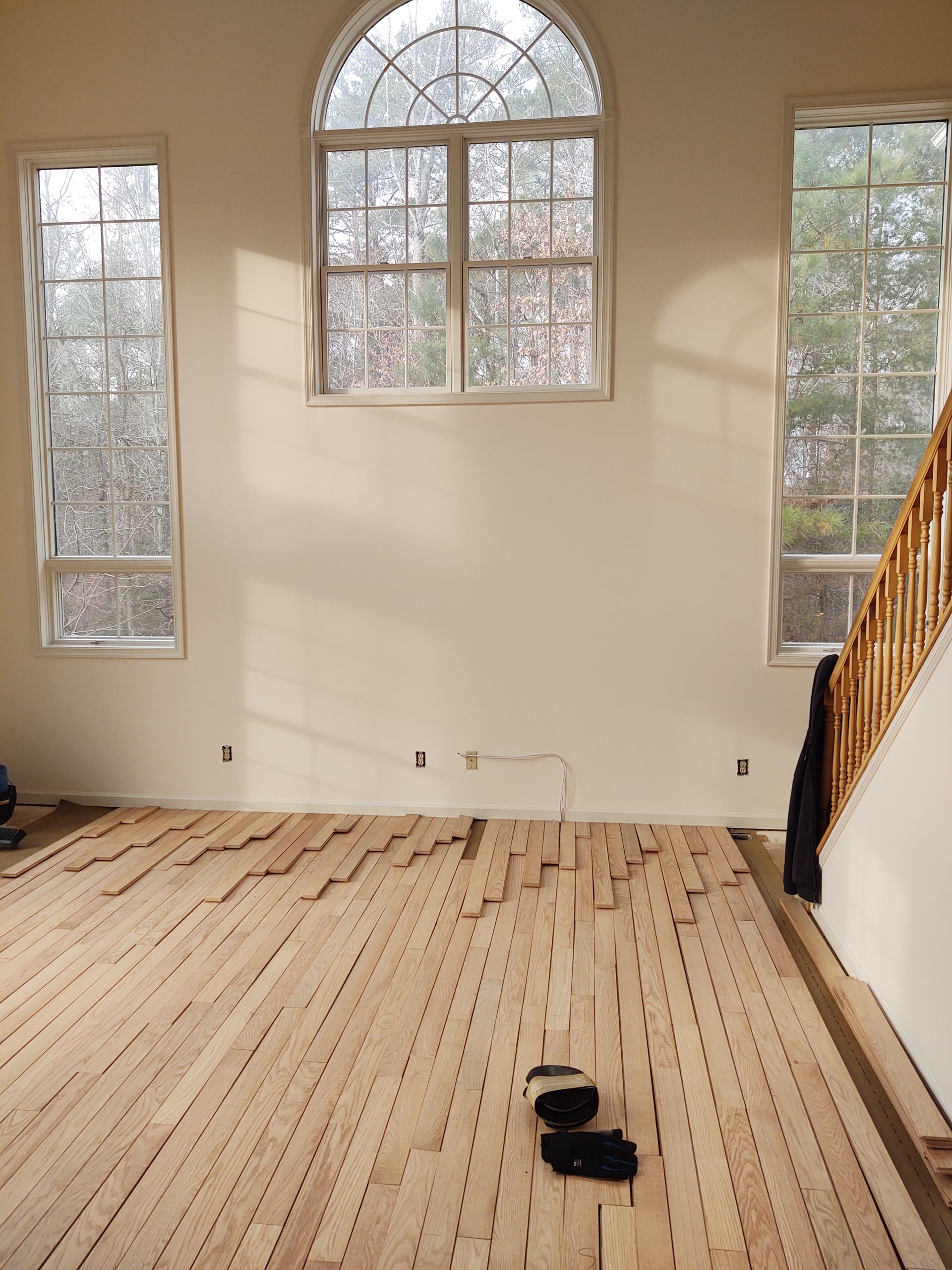 Beige carpet in a home with an open doorway to a kitchen and a dark wooden cabinet.